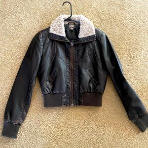 Short brown jacket with off white shearling collar. Zipper front.